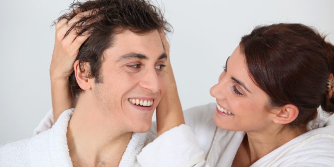 woman running hands through husband’s hair